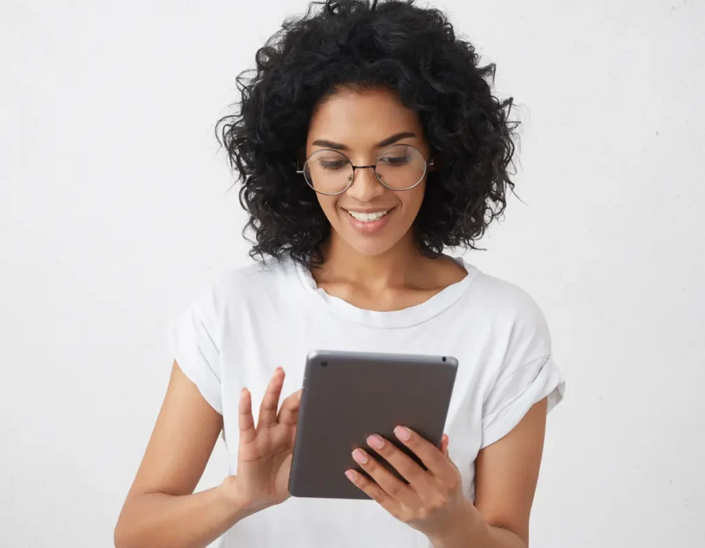 Mulher usando o tablet para fazer o seu controle de ponto digital ao invés de ponto eletrônico para academia